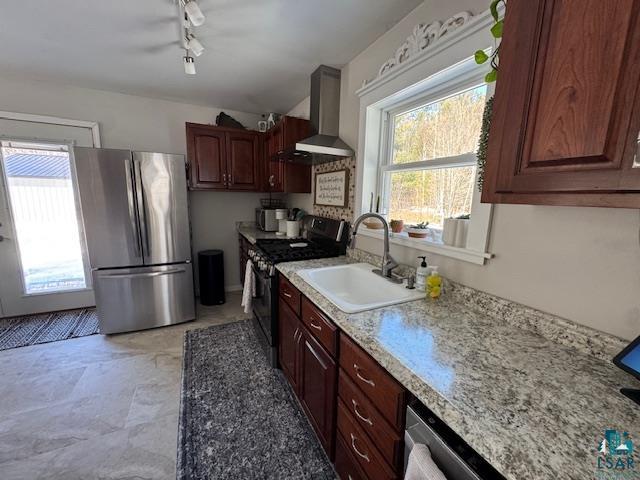 15081 Old Hart Lake Road Goodland, MN 55742 - Photo 5 of 18 Kitchen with range, freestanding refrigerator, and wall chimney range hood