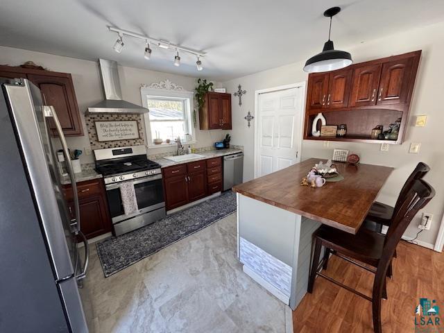 15081 Old Hart Lake Road Goodland, MN 55742 - Photo 5 of 19 Kitchen with stainless steel appliances, a breakfast bar area, a peninsula, butcher block countertops, and open shelves