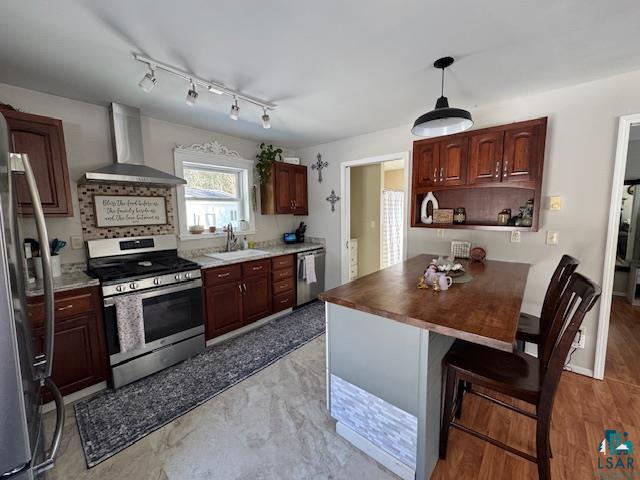 15081 Old Hart Lake Road Goodland, MN 55742 - Photo 6 of 18 Kitchen with stainless steel appliances, butcher block counters, a breakfast bar, hanging light fixtures, and open shelves