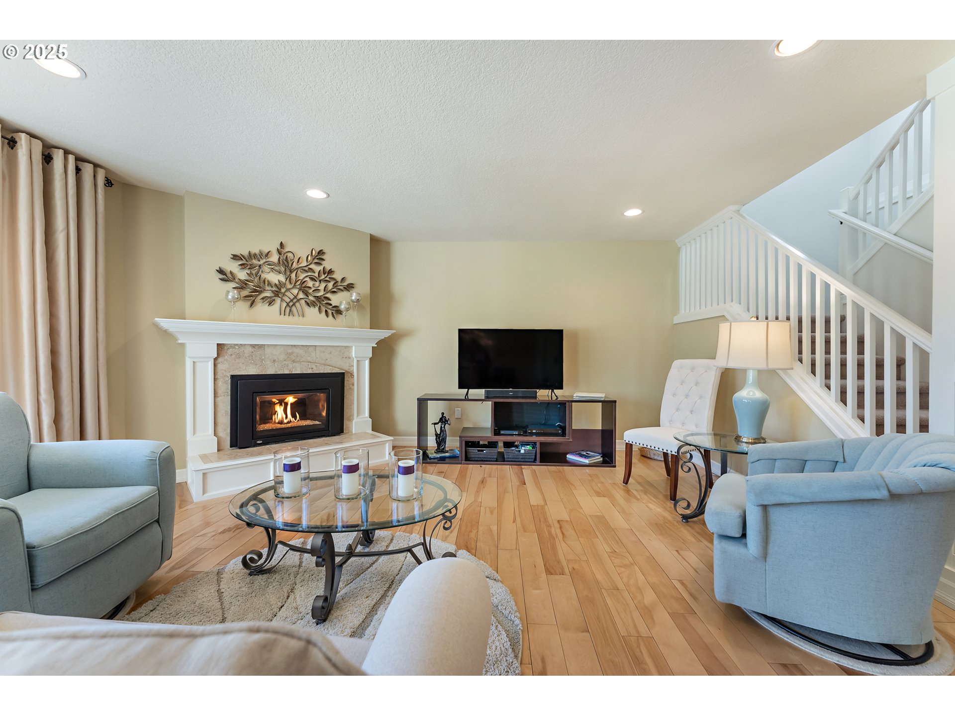 10350 Southwest Greenleaf Terrace Portland, OR 97224 - Photo 17 of 32 a living room with furniture a fireplace and a flat screen tv