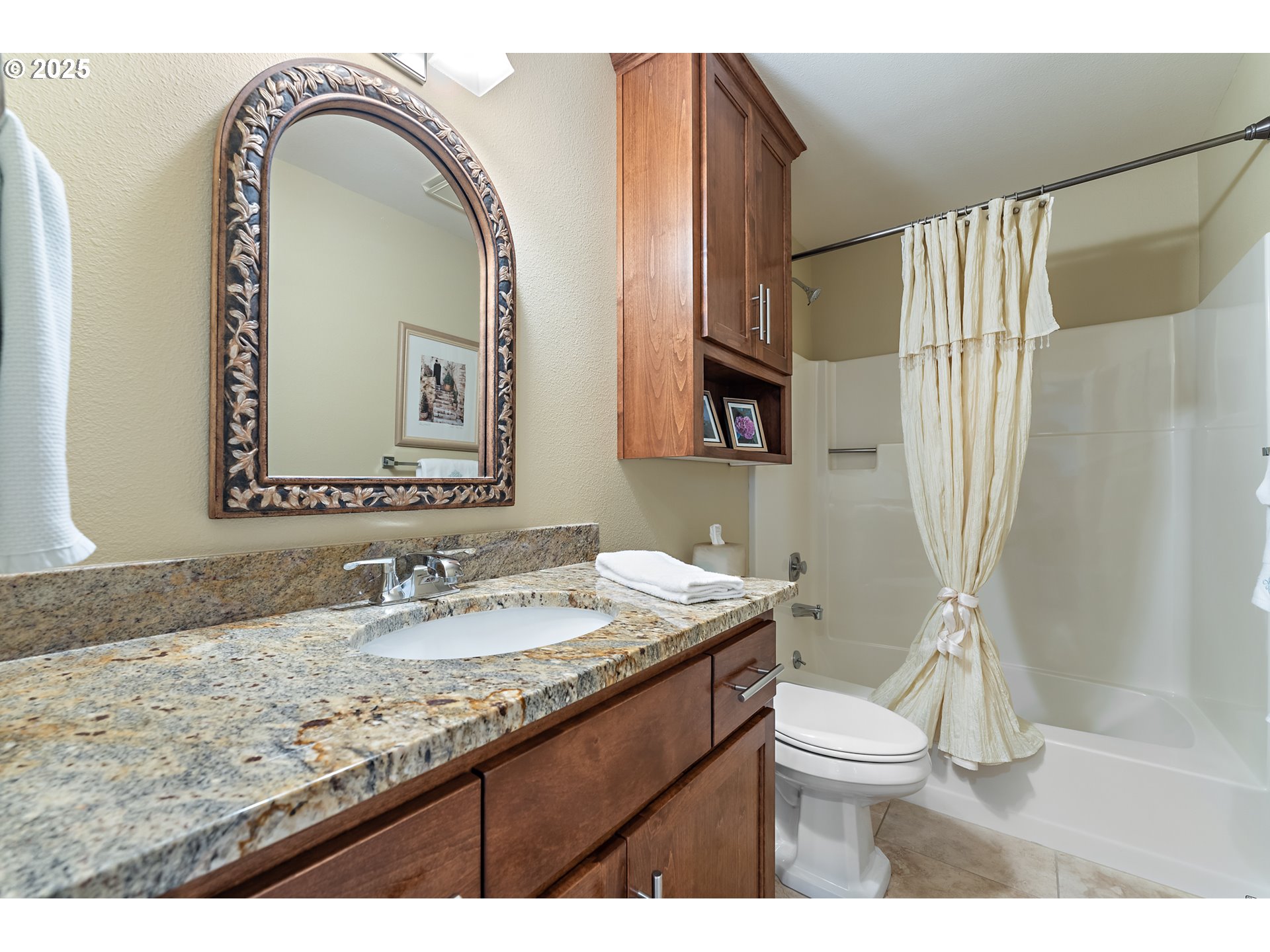10350 Southwest Greenleaf Terrace Portland, OR 97224 - Photo 20 of 32 a bathroom with a granite countertop sink a toilet and a mirror