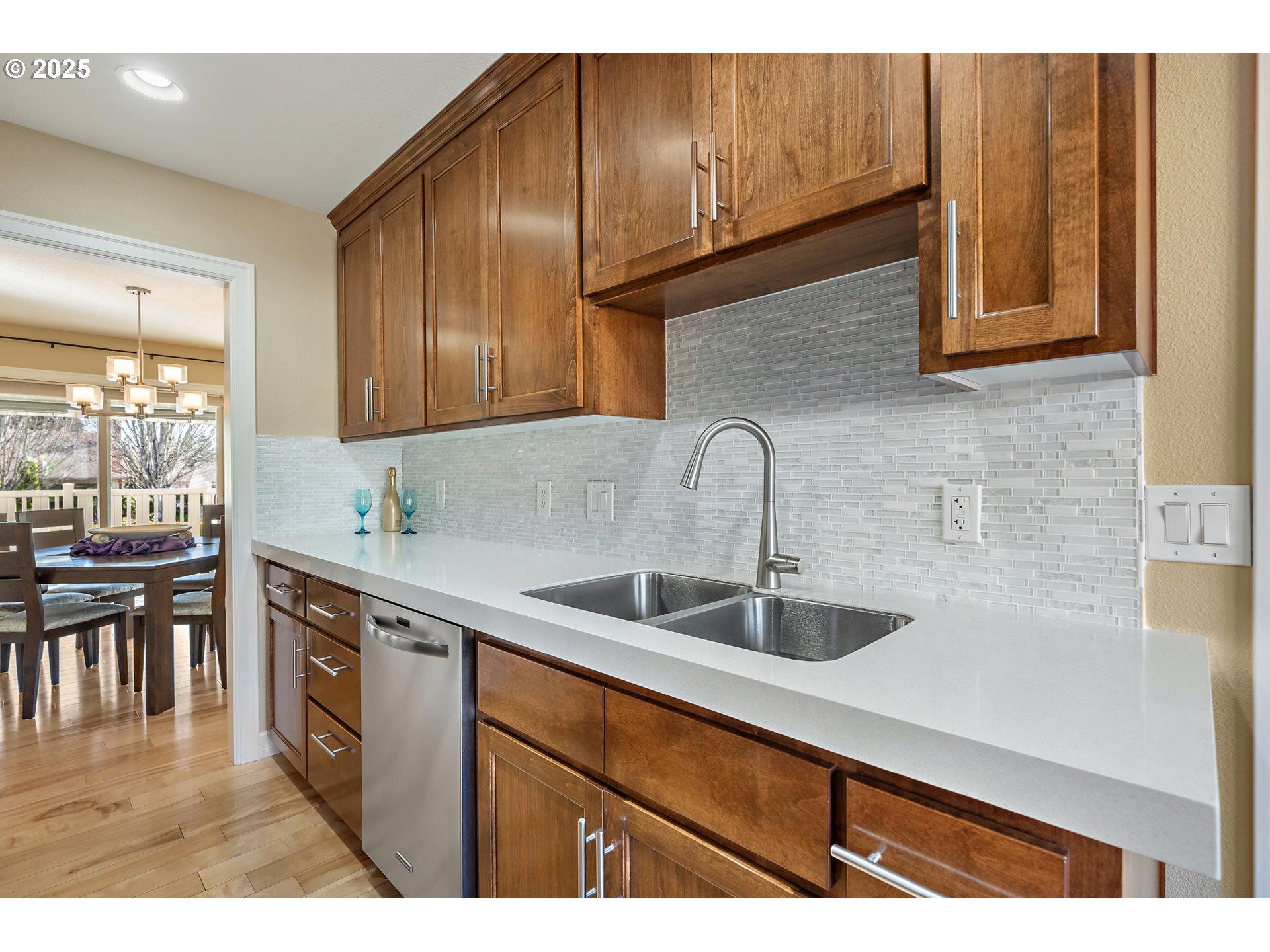10350 Southwest Greenleaf Terrace Portland, OR 97224 - Photo 9 of 32 a kitchen with stainless steel appliances granite countertop a sink and cabinets