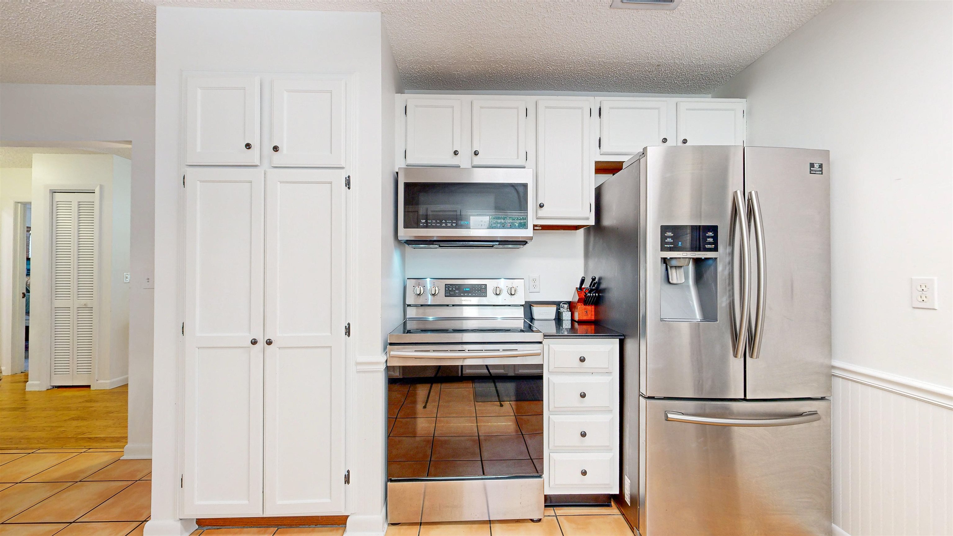 181 Hawthorne Road St. Augustine, FL 32086 - Photo 17 of 48 a kitchen with refrigerator a microwave and cabinets