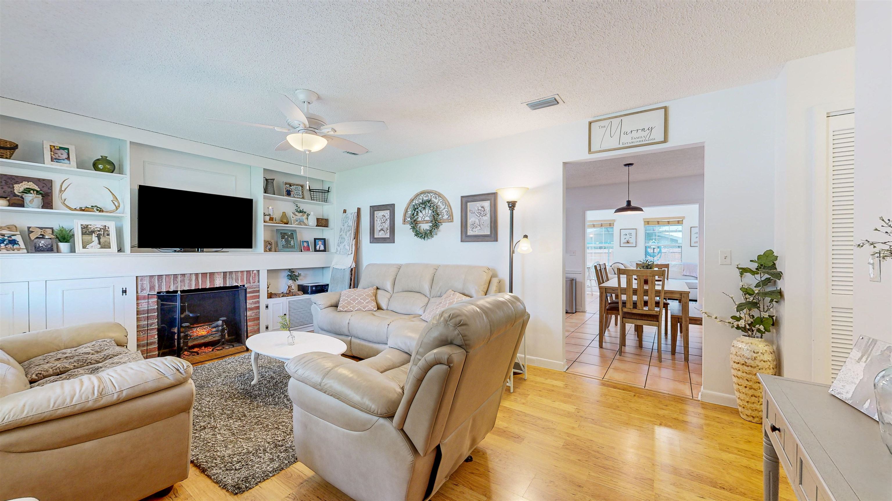 181 Hawthorne Road St. Augustine, FL 32086 - Photo 8 of 48 a living room with fireplace furniture and a flat screen tv
