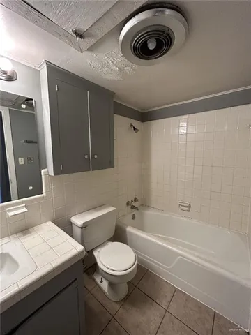a bathroom with a toilet a sink and bathtub