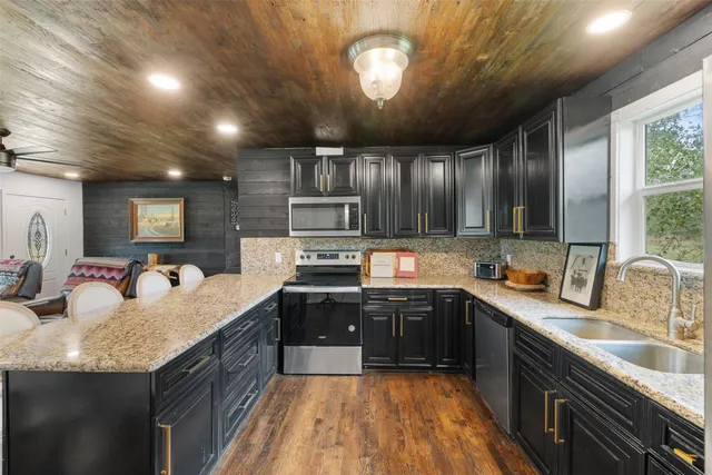 a large kitchen with granite countertop lots of counter top space