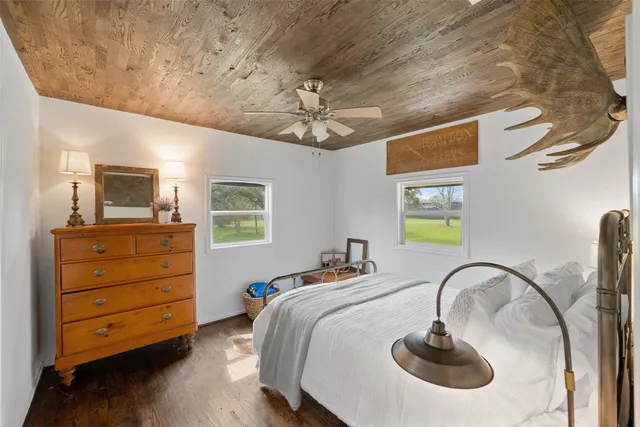 a bedroom with a bed and a painting on the wall