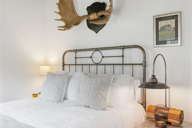 a bathroom with a granite countertop sink a toilet a shower and a mirror