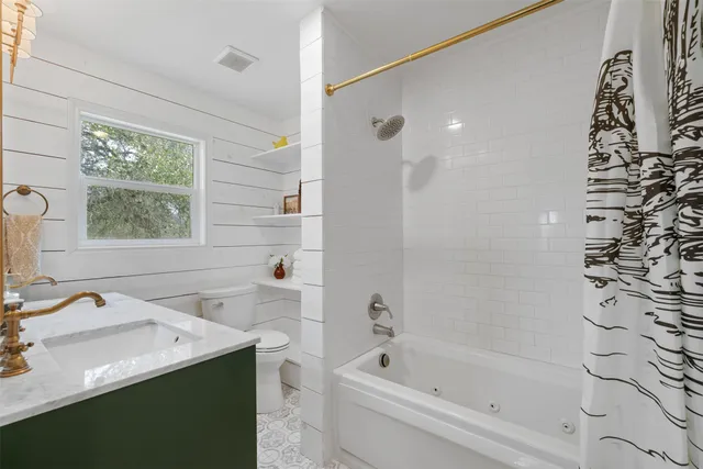 a bedroom with a bed a chandelier and a window