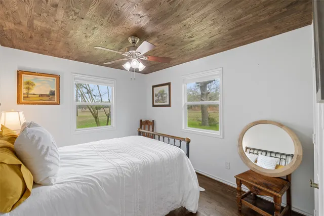 a view of a chair and table in backyard of the house