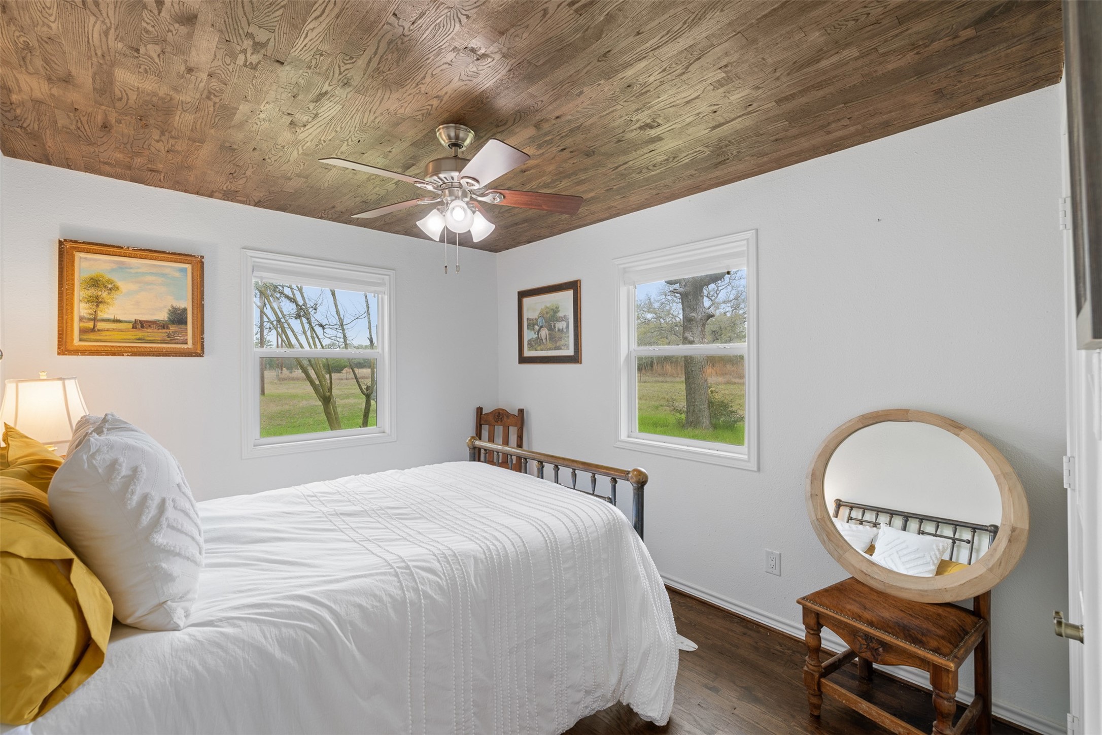 2407 East State Highway 159 Fayetteville, TX 78940 - Photo 19 of 35 a bedroom with a bed a chandelier and a window