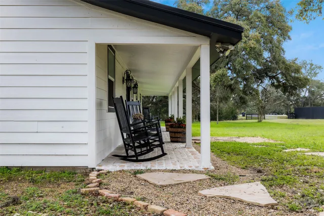 a backyard of a house with table and chairs