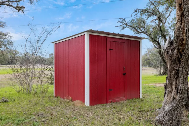 a yard with trees in the background
