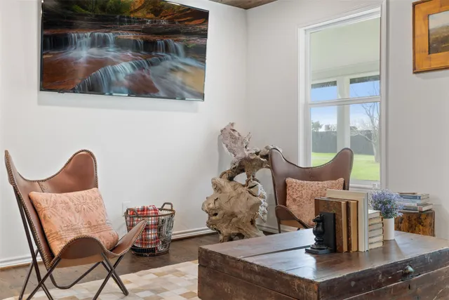 a dining room with furniture and wooden floor