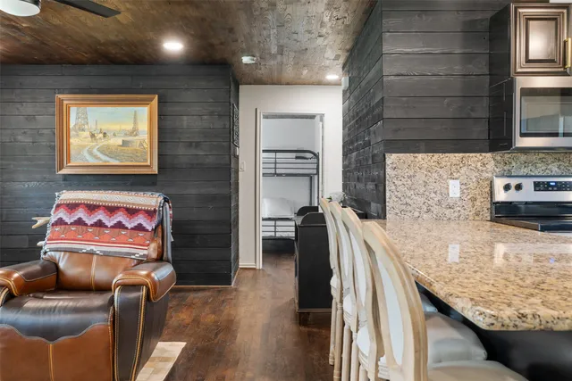 a hallway with furniture and a flat screen tv