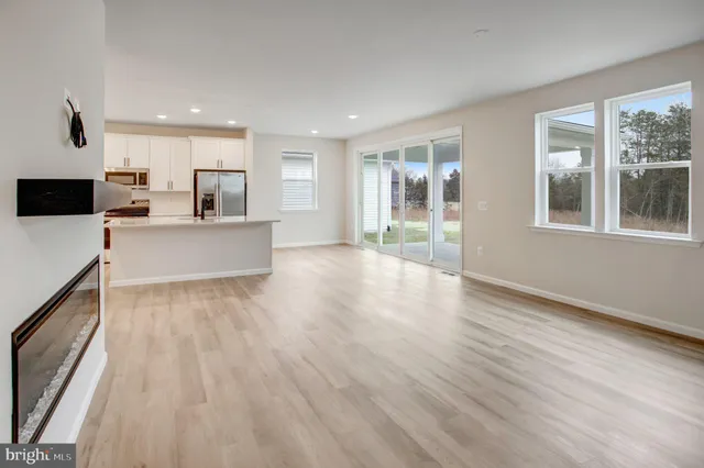 a view of a kitchen with furniture and wooden floor