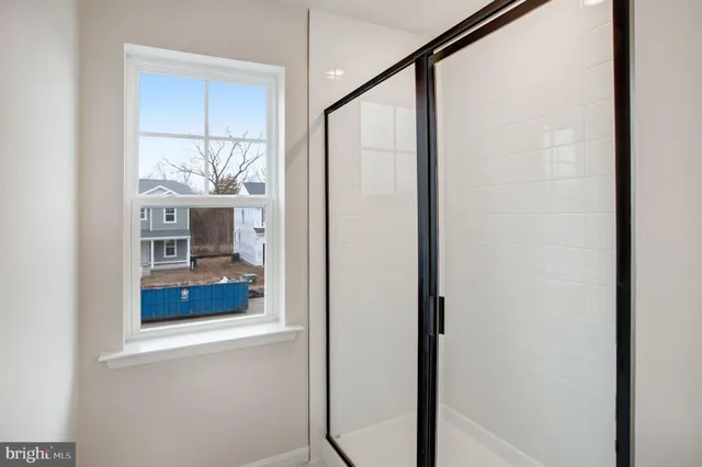 a bathroom with a glass shower door and mirror