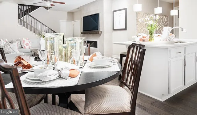 a view of a dining room with furniture and a flat screen tv