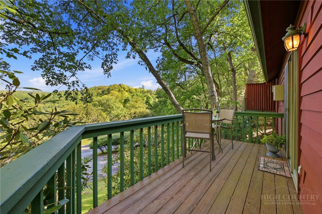 140 Lindale Ridge, Unit 504 Boone, NC 28607 - Photo 10 of 15 a balcony with wooden floor and outdoor seating