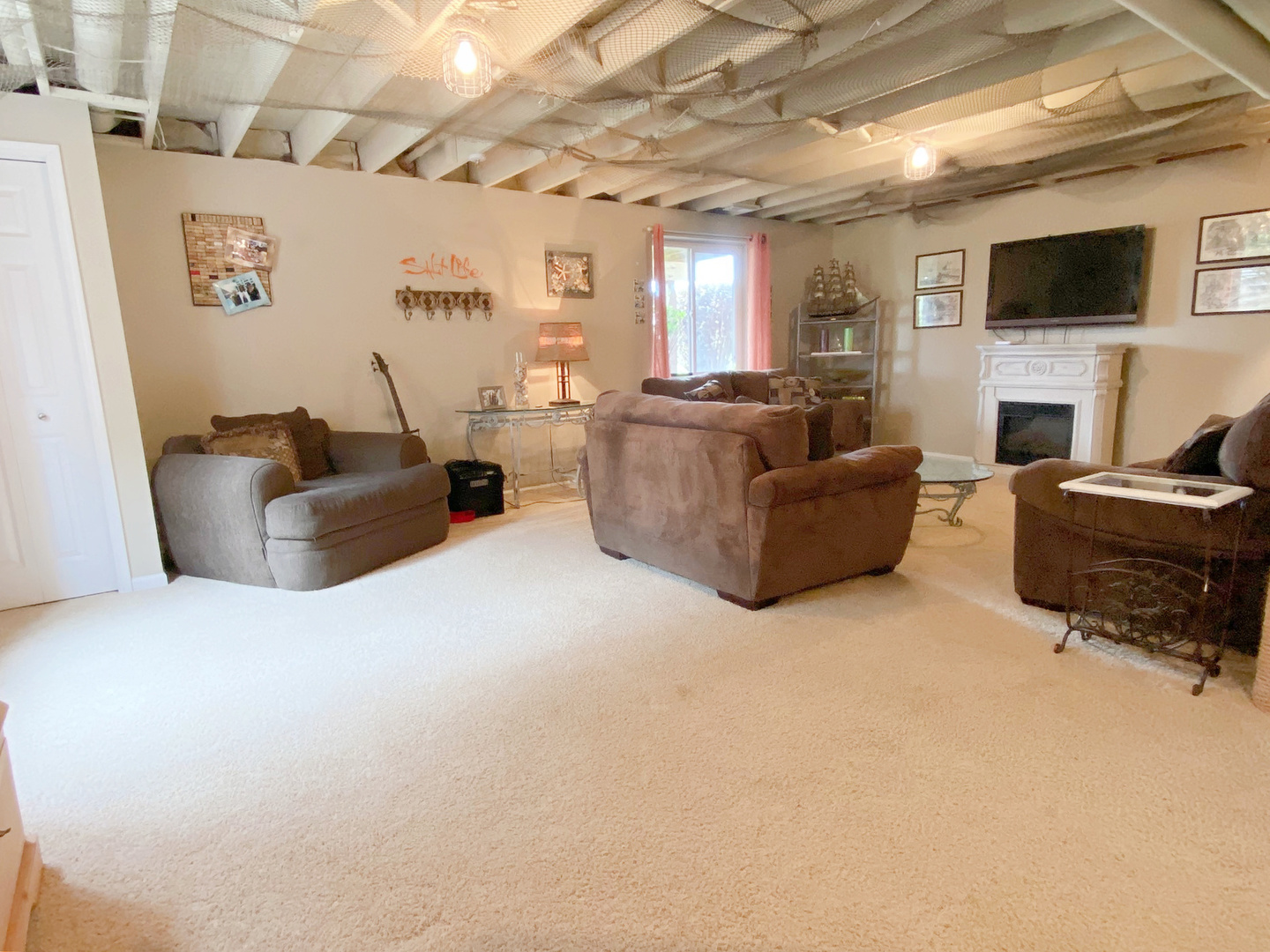 1197 Freedom Road Elburn, IL 60119 - Photo 24 of 31 a living room with furniture a flat screen tv and a fireplace