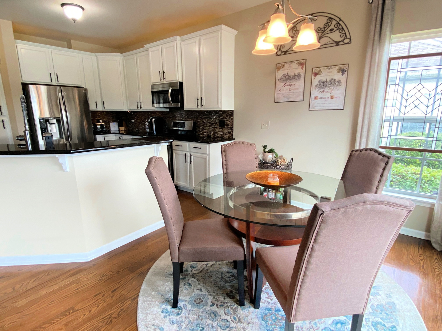 1197 Freedom Road Elburn, IL 60119 - Photo 6 of 31 a kitchen with stainless steel appliances a dining table and chairs