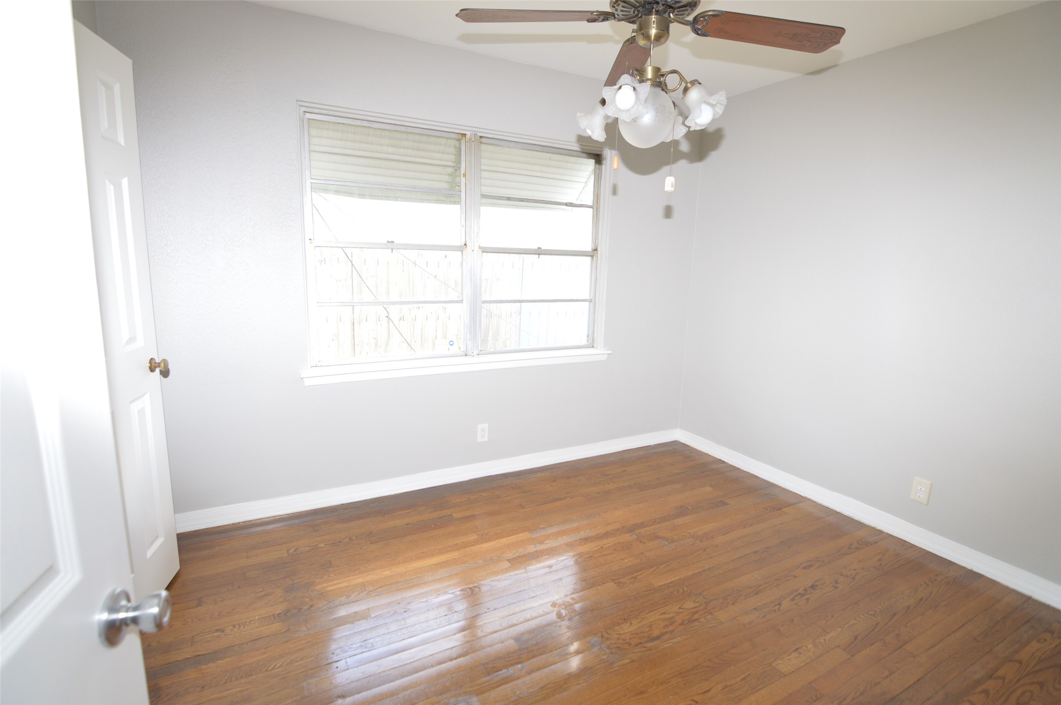 1403 Elton Street Houston, TX 77034 - Photo 13 of 21 wooden floor in an empty room with a window