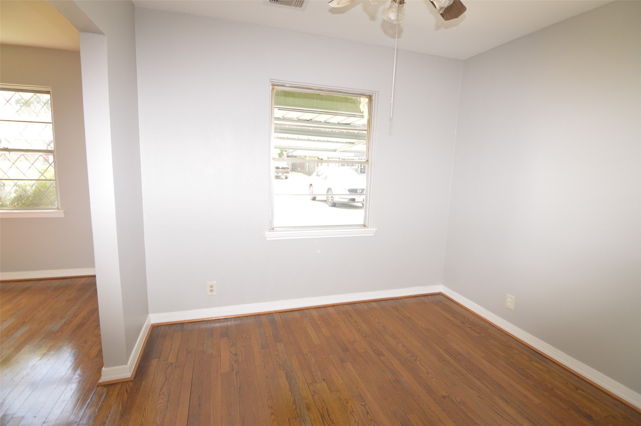 1403 Elton Street Houston, TX 77034 - Photo 6 of 21 an empty room with wooden floor and windows
