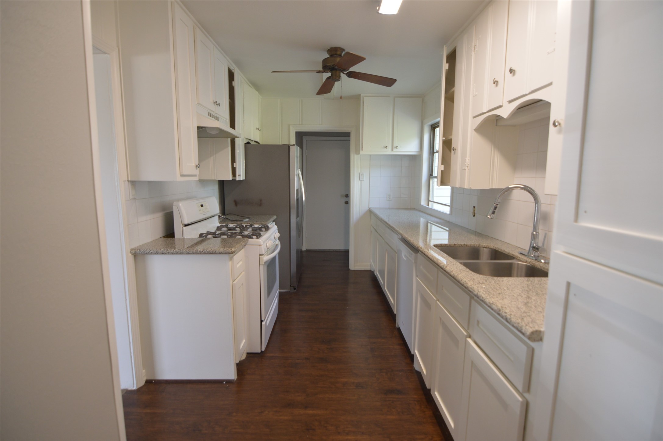 1403 Elton Street Houston, TX 77034 - Photo 9 of 21 a kitchen with a sink stove and refrigerator