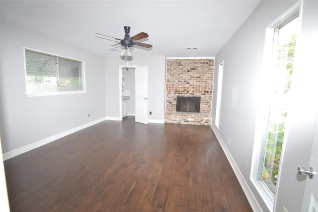 a view of an entryway with wooden floor and a ceiling fan