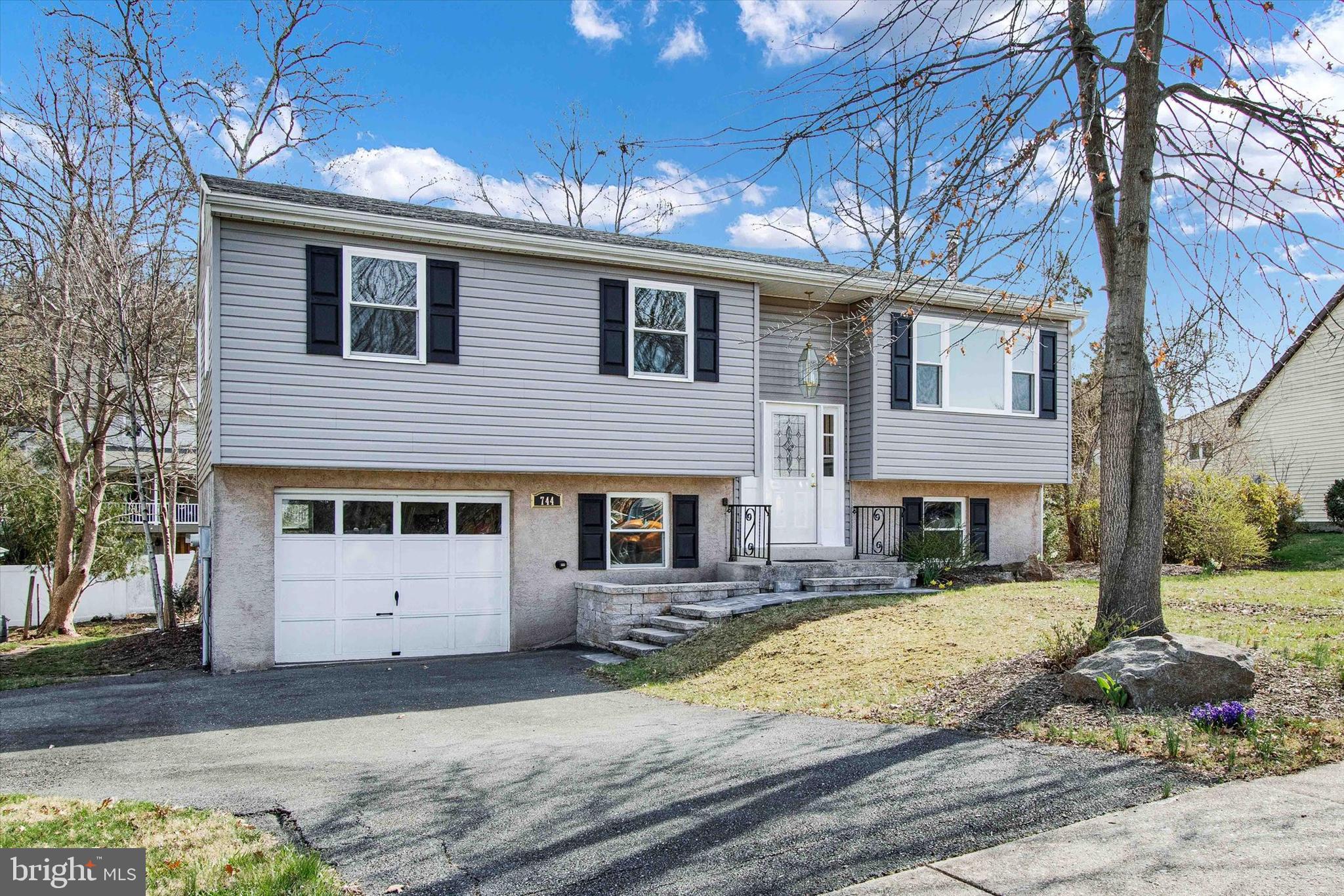 744 Tamarack Trail Reading, PA 19607 - Photo 1 of 27 a view of a white house with a large tree in front of it