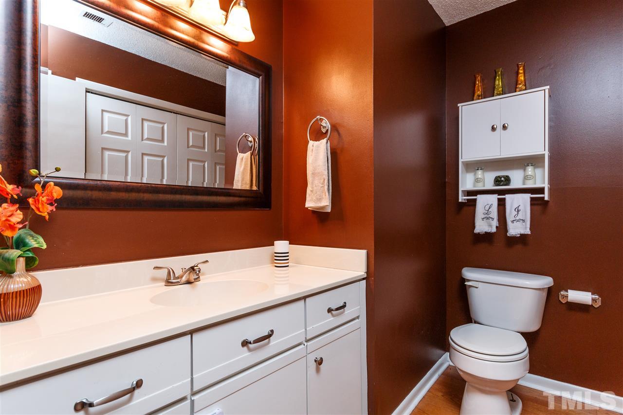 4411 Sunscape Lane Raleigh, NC 27613 - Photo 14 of 25 a bathroom with a sink a toilet and mirror