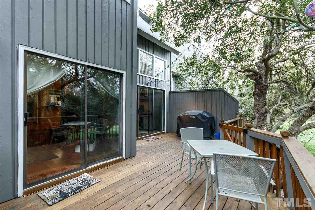 4411 Sunscape Lane Raleigh, NC 27613 - Photo 22 of 25 a backyard of a house with wooden floor table and chairs