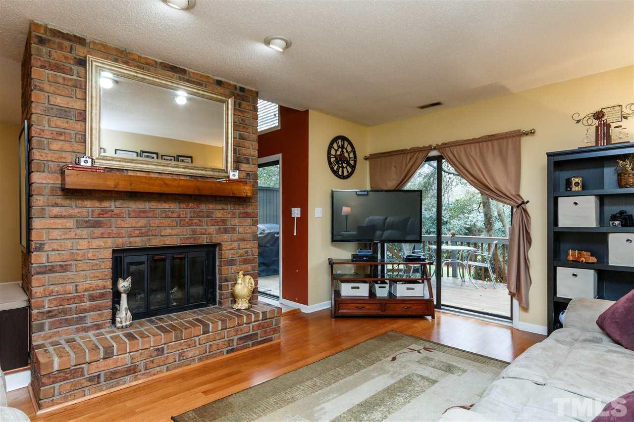4411 Sunscape Lane Raleigh, NC 27613 - Photo 4 of 25 a living room with furniture and a fireplace