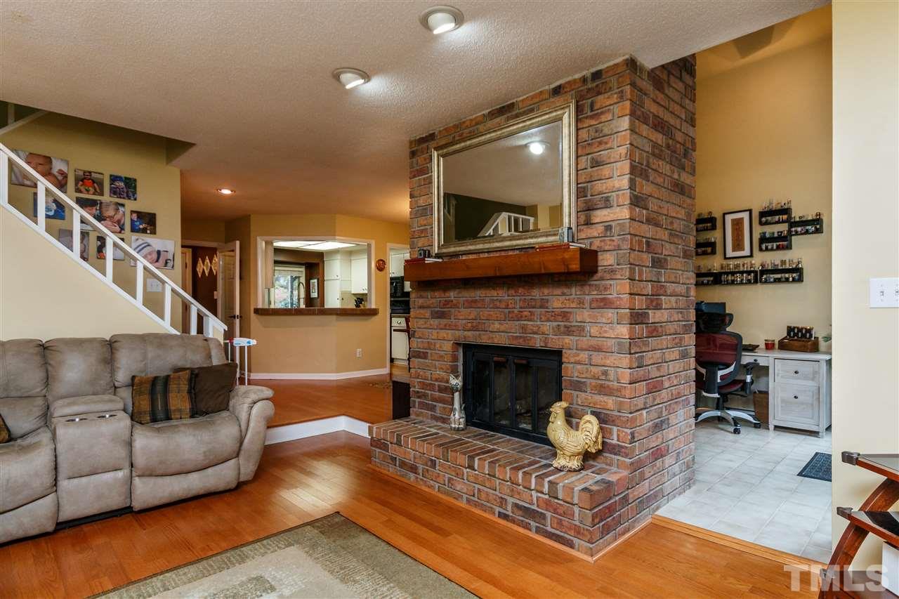 4411 Sunscape Lane Raleigh, NC 27613 - Photo 5 of 25 a living room with furniture and a fireplace
