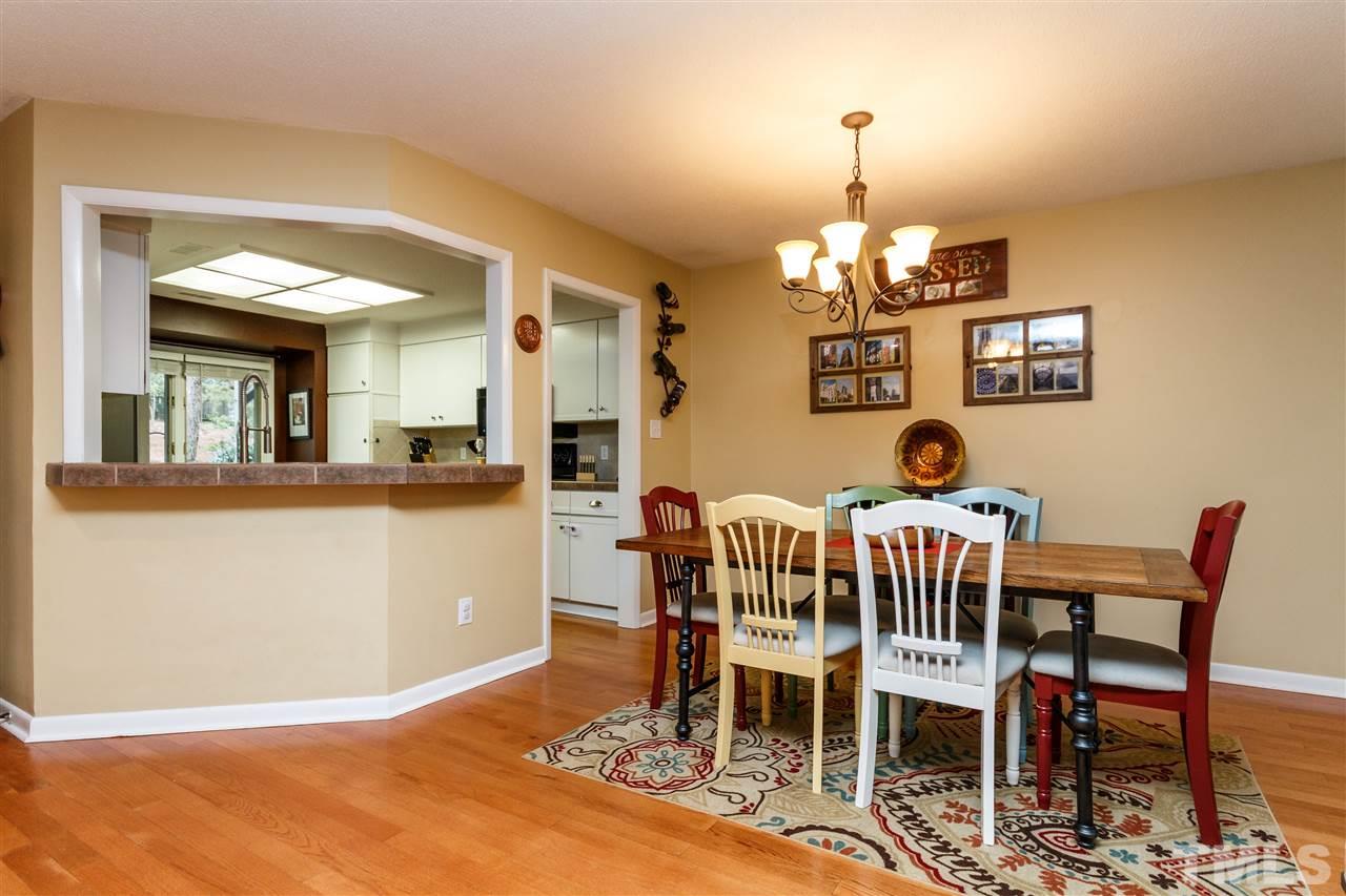 4411 Sunscape Lane Raleigh, NC 27613 - Photo 9 of 25 a dining room with furniture a chandelier and window