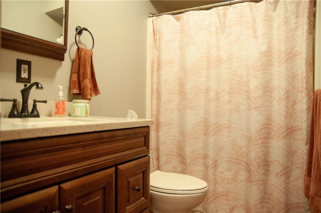 687 Bullcreek Road Butler, PA 16002 - Photo 13 of 19 a bathroom with a sink a toilet and shower curtain