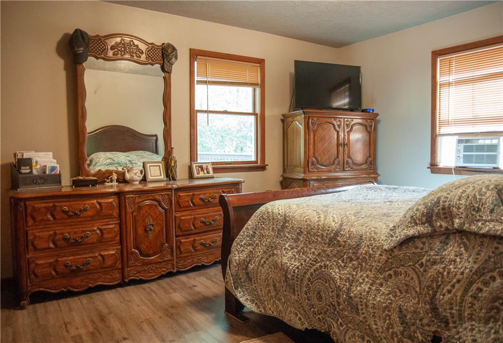 687 Bullcreek Road Butler, PA 16002 - Photo 14 of 19 a spacious bedroom with a bed and a dresser next to a window
