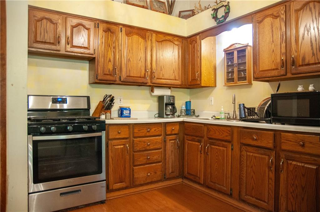 687 Bullcreek Road Butler, PA 16002 - Photo 9 of 19 a kitchen with stainless steel appliances granite countertop wooden cabinets stove top oven and sink