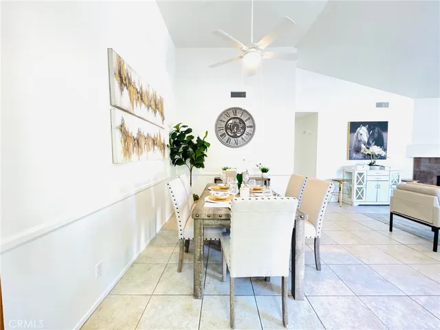 a dining room with furniture and a clock