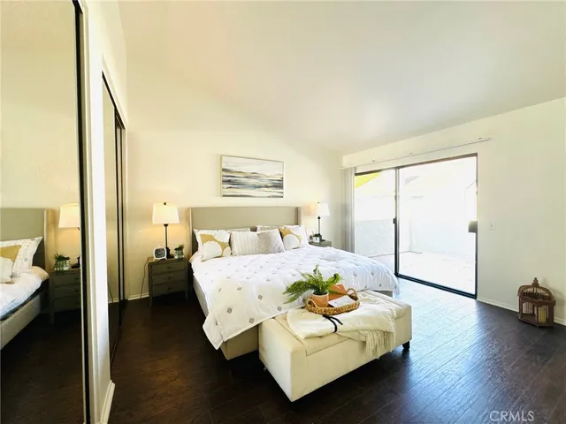 a spacious bedroom with a bed and a couch