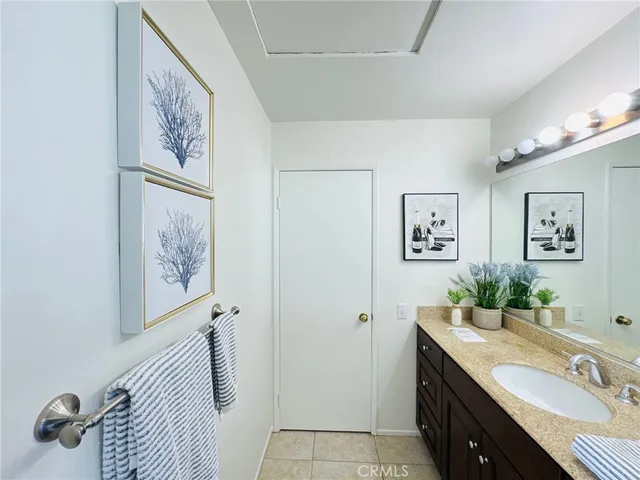 a bathroom with a sink and mirror with toilet
