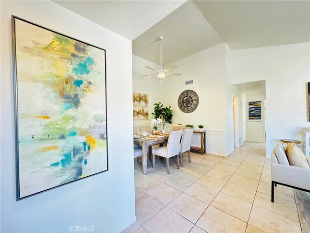 a living room with couches and painting on the wall