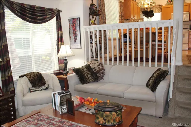 a living room with a fireplace and a book shelf