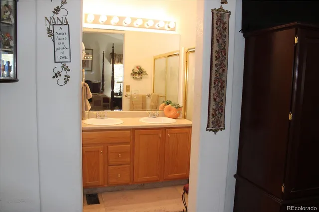 a bathroom with a granite countertop sink a toilet and shower