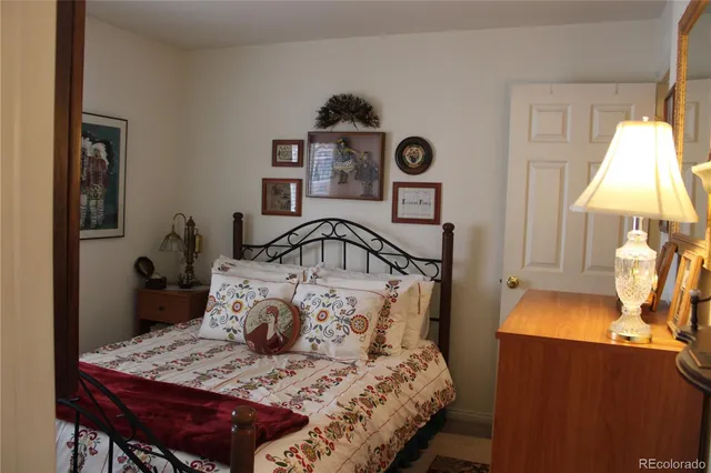 a view of a bedroom with closet and mirror