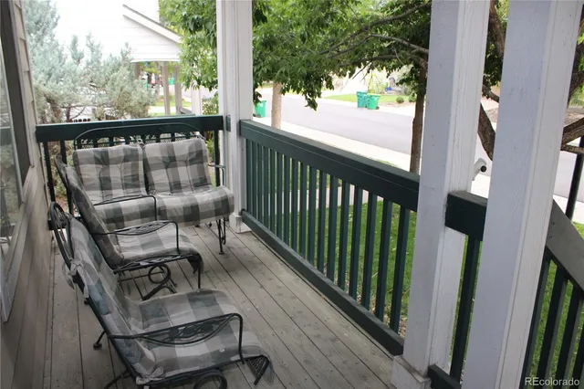 a view of balcony with wooden floor and outdoor seating