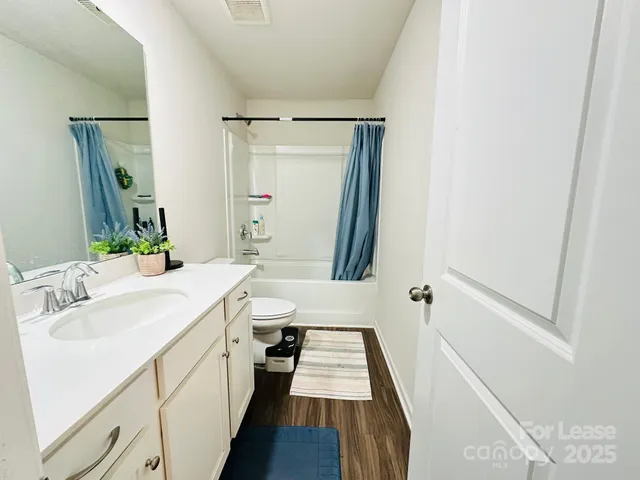 a bathroom with a sink a mirror and a shower