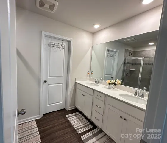 a bathroom with a double vanity sink and mirror
