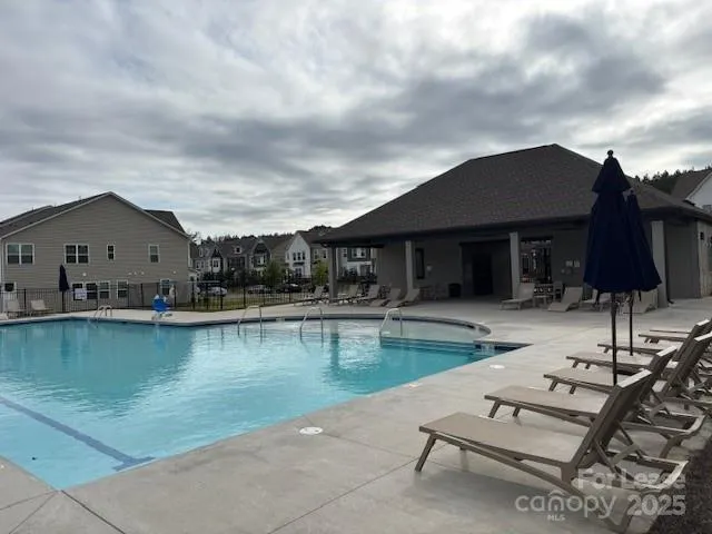 a view of house with swimming pool and chair