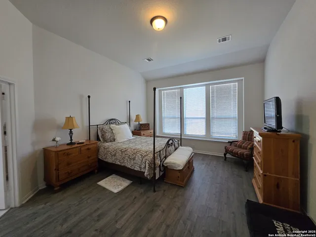 a bedroom with bed and window